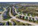 Aerial view of a beautiful neighborhood with winding roads, lush greenery, and sparkling lakes at 4706 Roycroft Ter, Parrish, FL 34219
