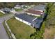 Aerial view showing the house with backyard screened-in lanai, mature trees, and manicured lawn at 4706 Roycroft Ter, Parrish, FL 34219