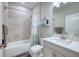 Clean bathroom with shower over tub, tile details and gray vanity at 4706 Roycroft Ter, Parrish, FL 34219