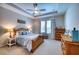 Comfortable bedroom with wood furniture, ceiling fan, and a sunny window at 4706 Roycroft Ter, Parrish, FL 34219