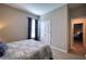 Cozy bedroom featuring a double bed, window with curtains, and closet with double doors at 4706 Roycroft Ter, Parrish, FL 34219
