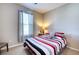 Cozy bedroom features a ceiling fan, a large window, and stylish decor at 4706 Roycroft Ter, Parrish, FL 34219