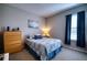 Comfortable bedroom featuring a double bed, a dresser, a window with curtains, and carpeted floors at 4706 Roycroft Ter, Parrish, FL 34219