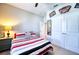 Cozy bedroom features a ceiling fan, a large window, and stylish decor at 4706 Roycroft Ter, Parrish, FL 34219