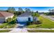 Beautiful single-story home with a well-manicured lawn, mature trees and a two car garage at 4706 Roycroft Ter, Parrish, FL 34219