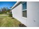 Exterior shot highlighting the pristine stucco finish, manicured garden bed and a well-placed window at 4706 Roycroft Ter, Parrish, FL 34219