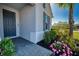 Charming home exterior with a blue front door, manicured landscaping, and a paved walkway at 4706 Roycroft Ter, Parrish, FL 34219