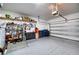 Spacious two car garage featuring epoxy floor, storage shelving and an automatic door at 4706 Roycroft Ter, Parrish, FL 34219