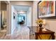 Inviting hallway with wood floors, neutral paint, and a view of the living area and adjacent bathroom at 4706 Roycroft Ter, Parrish, FL 34219