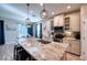 Kitchen island with granite countertops, pendant lights, and breakfast bar seating at 4706 Roycroft Ter, Parrish, FL 34219
