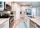 Bright kitchen with stainless steel appliances, granite counters, and gray backsplash at 4706 Roycroft Ter, Parrish, FL 34219