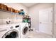 Well-equipped laundry room with a washer, dryer, and storage shelves at 4706 Roycroft Ter, Parrish, FL 34219