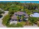 An aerial view captures the beautiful home, pool, and neighborhood near the ocean at 4940 Peaceable Way, Sarasota, FL 34242