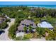 Expansive aerial view showcasing the property's proximity to lush greenery and the calming ocean waters at 4940 Peaceable Way, Sarasota, FL 34242