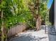 Lush backyard featuring mature trees, a gravel path and privacy fence at 4940 Peaceable Way, Sarasota, FL 34242