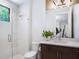 Bathroom features a glass shower, modern fixtures, and a single sink vanity at 4940 Peaceable Way, Sarasota, FL 34242