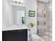 Bathroom featuring a glass-enclosed shower, modern fixtures, and decorative wall tiles at 4940 Peaceable Way, Sarasota, FL 34242