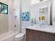 Clean and bright bathroom featuring modern vanity, stylish mirror, and a shower-tub combination at 4940 Peaceable Way, Sarasota, FL 34242