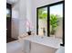 Bright bathroom featuring soaking tub with a large window for natural light and a modern shower at 4940 Peaceable Way, Sarasota, FL 34242