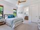 Comfortable bedroom featuring a large window, soft lighting, and an adjoining bathroom at 4940 Peaceable Way, Sarasota, FL 34242