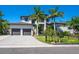 Two-story home with palm trees, well-manicured lawn, and two-car garage at 4940 Peaceable Way, Sarasota, FL 34242