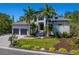 Two-story home with palm trees, well-manicured lawn, and two-car garage at 4940 Peaceable Way, Sarasota, FL 34242