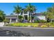 Two-story home with palm trees, well-manicured lawn, and two-car garage at 4940 Peaceable Way, Sarasota, FL 34242