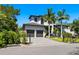 Modern two-story home with a lushly landscaped front yard and a two-car garage at 4940 Peaceable Way, Sarasota, FL 34242