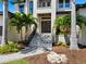 Inviting front entrance featuring a modern door, complemented by lush landscaping and a stone pathway at 4940 Peaceable Way, Sarasota, FL 34242