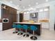 A contemporary kitchen features a large island with seating, stainless steel appliances, and modern cabinetry at 4940 Peaceable Way, Sarasota, FL 34242