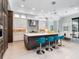 A modern kitchen features a large island with seating, stainless steel appliances, and modern cabinetry at 4940 Peaceable Way, Sarasota, FL 34242