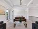 Upstairs living room with comfortable seating, recessed lights, and a view of tropical foliage at 4940 Peaceable Way, Sarasota, FL 34242