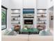 Stylish living room boasts a modern fireplace, custom shelving, and comfortable seating for relaxation at 4940 Peaceable Way, Sarasota, FL 34242