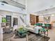 Spacious living room featuring soaring ceilings, an open floor plan, and easy access to the modern kitchen at 4940 Peaceable Way, Sarasota, FL 34242