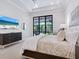 Bright and airy main bedroom with access to a screened patio and pool view at 4940 Peaceable Way, Sarasota, FL 34242