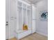 Well-organized mudroom with built-in storage, bench seating, and a coat rack at 4940 Peaceable Way, Sarasota, FL 34242