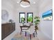 A modern office space featuring bright natural light, white walls, and a stylish rug and decor at 4940 Peaceable Way, Sarasota, FL 34242