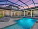 Beautiful pool with spa and sun shelf, modern outdoor kitchen and ample patio seating at 4940 Peaceable Way, Sarasota, FL 34242
