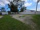Large backyard with grassy and bare areas surrounded by white vinyl fence at 503 Olive Ave, Nokomis, FL 34275