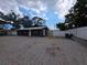 Wide exterior view of the home, showing ample parking with a brick paved drive at 503 Olive Ave, Nokomis, FL 34275