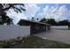 Exterior view of home showing partially finished features and brick paved outdoor space at 503 Olive Ave, Nokomis, FL 34275
