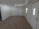 The spacious living room features new laminate floors, white walls, ceiling fan, and natural light at 503 Olive Ave, Nokomis, FL 34275