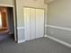Neutral bedroom with closet space and doorway leading to other room at 5701 Bentgrass Dr # 18-203, Sarasota, FL 34235