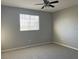 Bright bedroom with ceiling fan and window at 5701 Bentgrass Dr # 18-203, Sarasota, FL 34235
