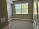 Cozy bedroom with a large window offering natural light and neutral carpeting at 5701 Bentgrass Dr # 18-203, Sarasota, FL 34235
