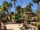 Exterior of home with outdoor seating surrounded by lush landscaping at 5701 Bentgrass Dr # 18-203, Sarasota, FL 34235