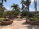 Charming tiered fountain surrounded by lush landscaping and seating areas at 5701 Bentgrass Dr # 18-203, Sarasota, FL 34235