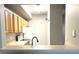 Kitchen with modern faucet, white appliances, and ample cabinet space at 5701 Bentgrass Dr # 18-203, Sarasota, FL 34235