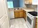 Cozy kitchen with stainless steel sink, white appliances, and tile flooring at 5701 Bentgrass Dr # 18-203, Sarasota, FL 34235