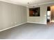Open-concept living area featuring neutral tones and plush carpeting at 5701 Bentgrass Dr # 18-203, Sarasota, FL 34235